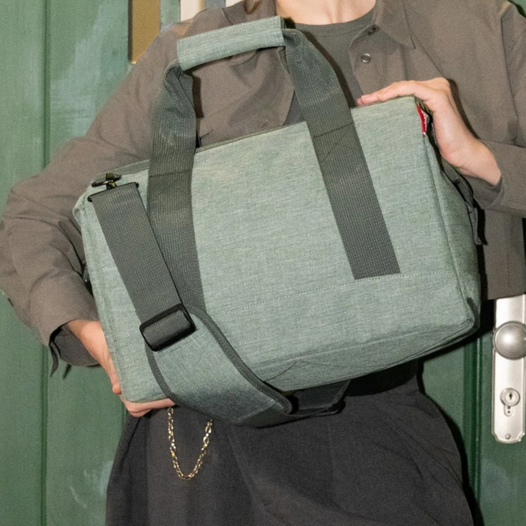 Lieblingstasche Allrounder M travel bag in sage green polyester with sturdy handles and adjustable shoulder strap