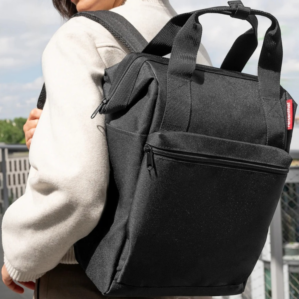 Lieblingstasche Allrounder R black insulated backpack with top handles and zippered front pocket worn on shoulders