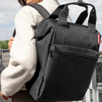 Lieblingstasche Allrounder R black insulated backpack with top handles and zippered front pocket worn on shoulders