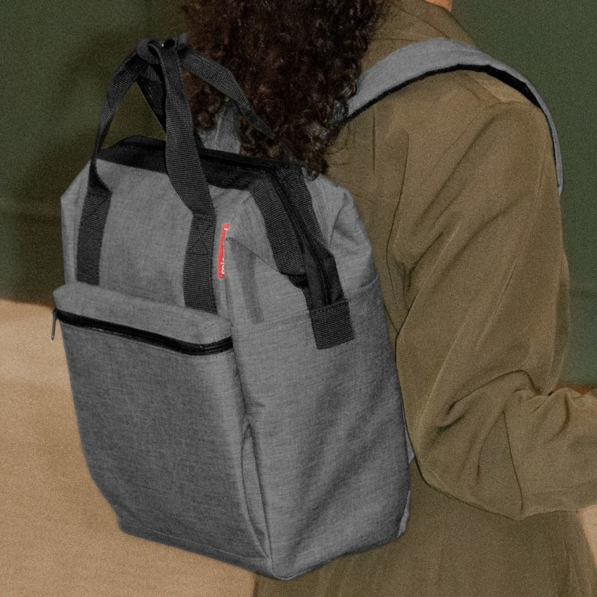 Lieblingstasche Allrounder R insulated backpack in grey worn on the back with black handles and zipper details