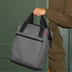 Lieblingstasche Allrounder R insulated grey thermal bag with black handles held by a person in a green outfit