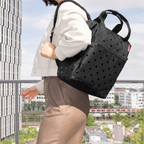 Lieblingstasche Allrounder R insulated backpack in black with polka dot pattern worn by a woman outdoors