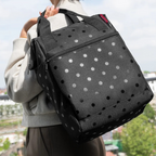 Lieblingstasche Allrounder R insulated backpack in black with grey polka dots worn on a person's shoulder