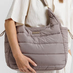 Lieblingstasche Alltime Buddy quilted taupe shoulder bag with gold hardware worn by a model