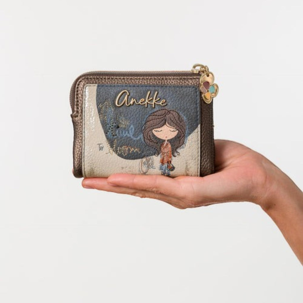 Lieblingstasche Anekke wallet featuring a whimsical girl illustration, metallic bronze trim, and a zip closure.