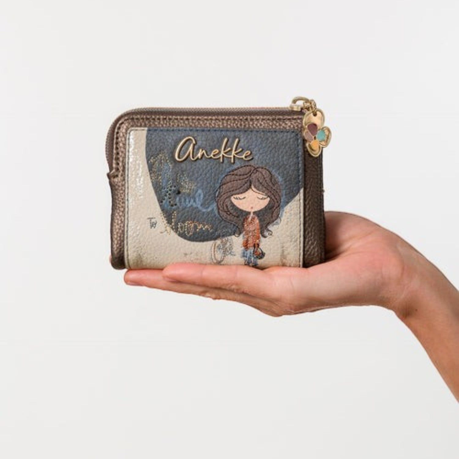 Lieblingstasche Anekke wallet featuring a whimsical girl illustration, metallic bronze trim, and a zip closure.