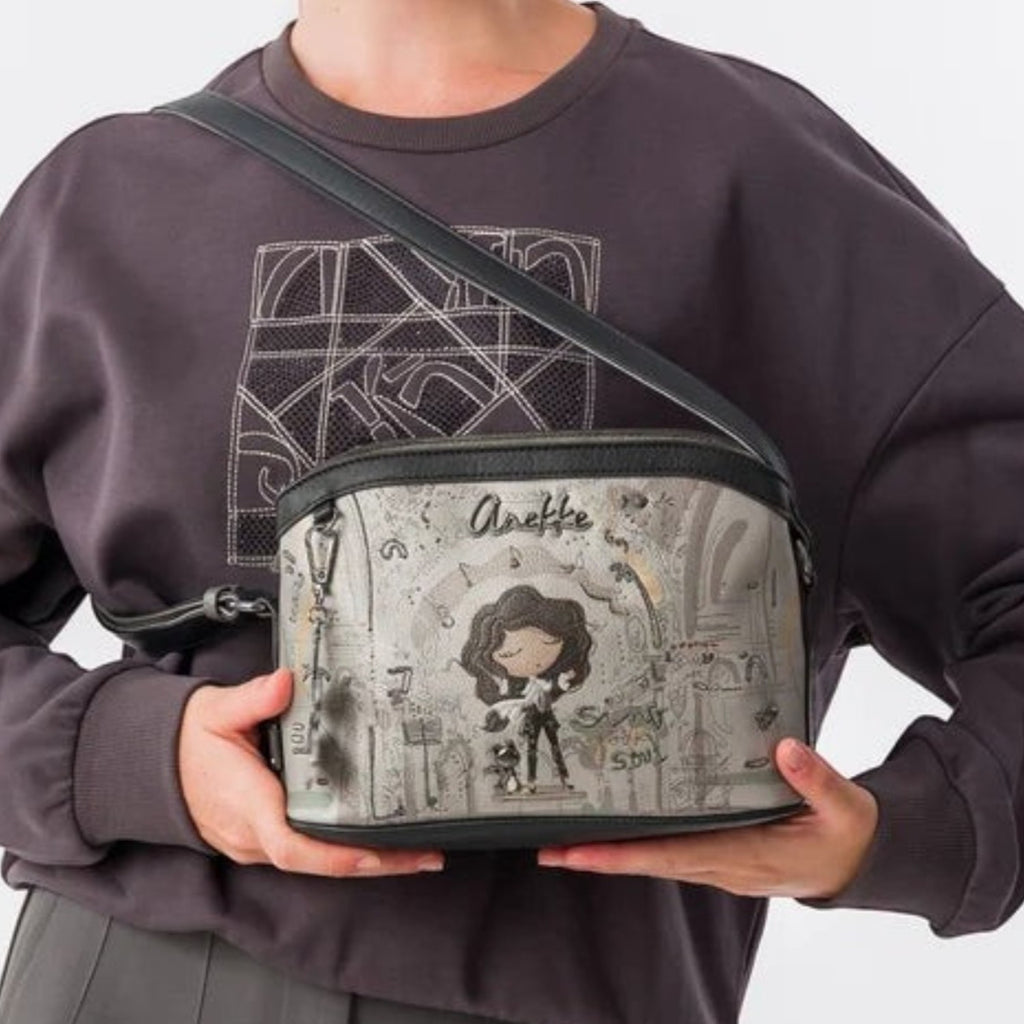 Lieblingstasche cross-body bag with Anekke graphic print, featuring a grey dome-shaped design and adjustable strap.