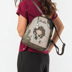 Woman wearing a Lieblingstasche Anekke backpack with illustrated character design and metallic bronze trim