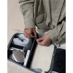 Lieblingstasche Bali Pro beige travel bag interior with organized compartments holding electronics, book, and clothing.