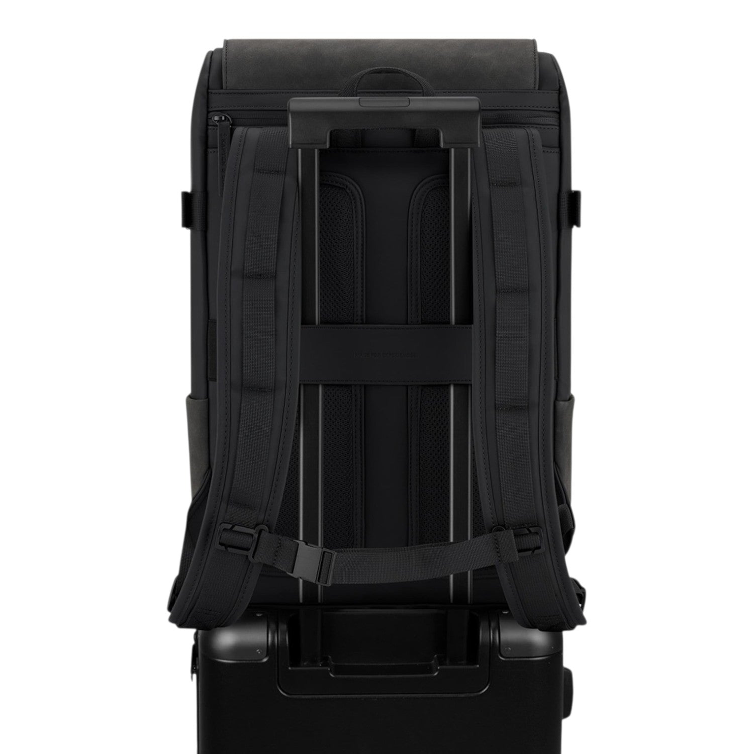 Lieblingstasche Bali Pro black backpack with padded straps and trolley sleeve, attached to a black suitcase.