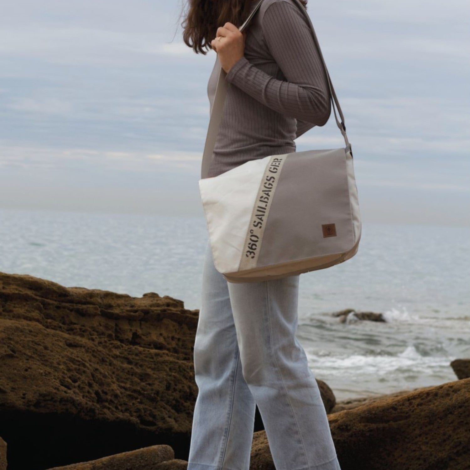 Lieblingstasche Barkasse shoulder bag made from recycled sailcloth with unique stitching and number detail on beach