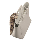 Lieblingstasche Tote L in beige canvas with a decorative leopard print silk scarf tied to the handle