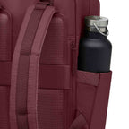 Lieblingstasche Bergen Pro burgundy backpack with padded straps and a side pocket holding a black water bottle