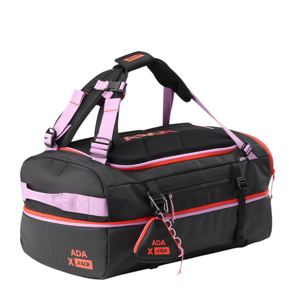 Lieblingstasche Duffel Pack in black with pink and orange accents, featuring durable fabric and adjustable straps.