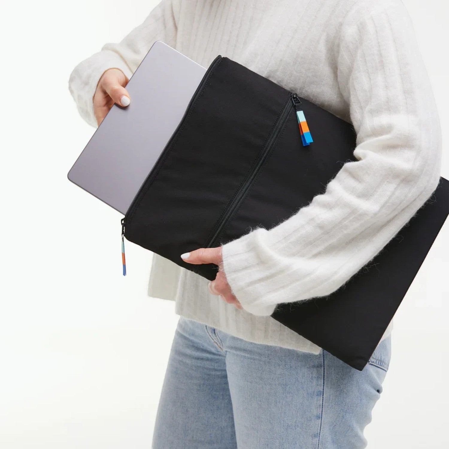 Lieblingstasche black removable laptop sleeve for 15 inch laptop with zipper closure held by a person