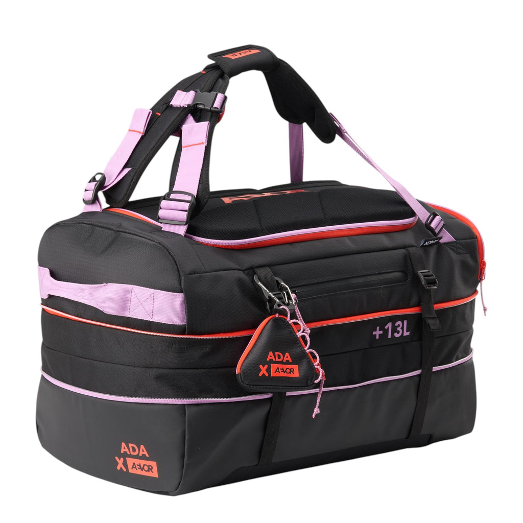 Lieblingstasche black duffel pack with pink accents, adjustable straps, and branded detailing on a white background.