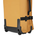 Lieblingstasche BOLONIA M rolling travel bag in mustard yellow fabric with black wheels and straps.