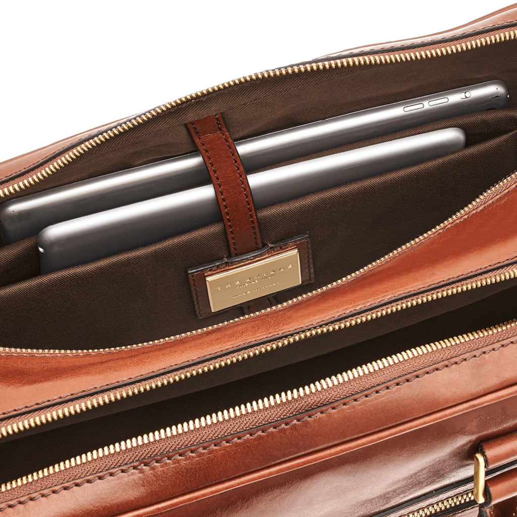 Lieblingstasche brown leather briefcase interior with two tablets secured by a leather strap.