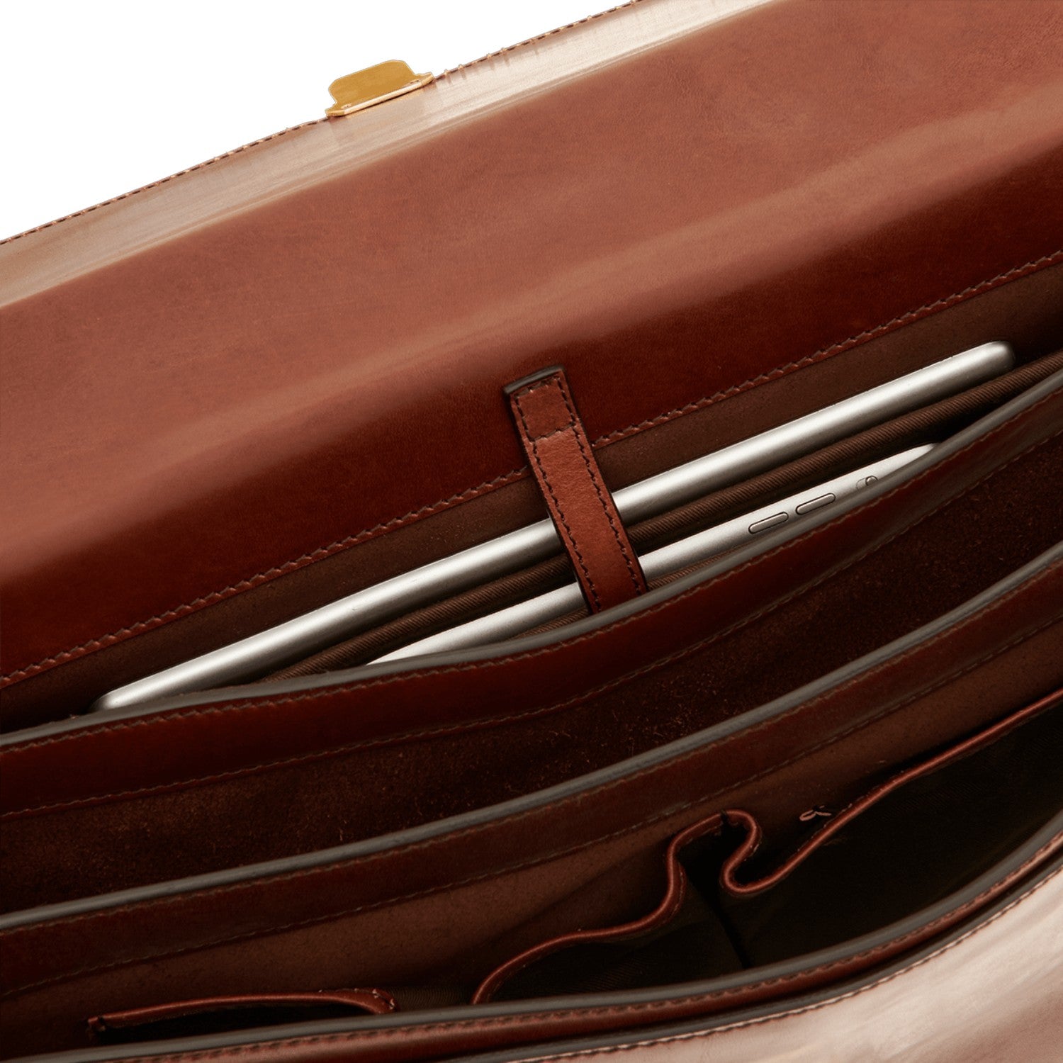 Lieblingstasche brown leather briefcase interior with a tablet secured by a leather strap.