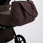 Lieblingstasche Cloud Horizon brown padded tote bag hanging from a stroller handle