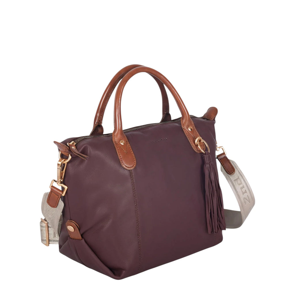 Lieblingstasche Lucia M deep burgundy leather handbag with tan leather handles and tassel detail.