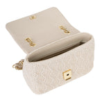 Lieblingstasche Ocarina summer flap bag in cream woven material with gold chain strap and gold clasp.