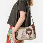 Lieblingstasche cross-body bag with illustrated girl graphic, worn by a woman against a white background
