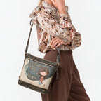 Lieblingstasche cross-body bag featuring a whimsical girl illustration, worn by a model in a brown blouse and trousers