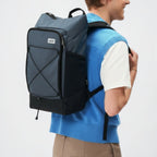 Lieblingstasche Day Pack FLX in blue and black with front bungee cord and mesh side pockets worn by a model