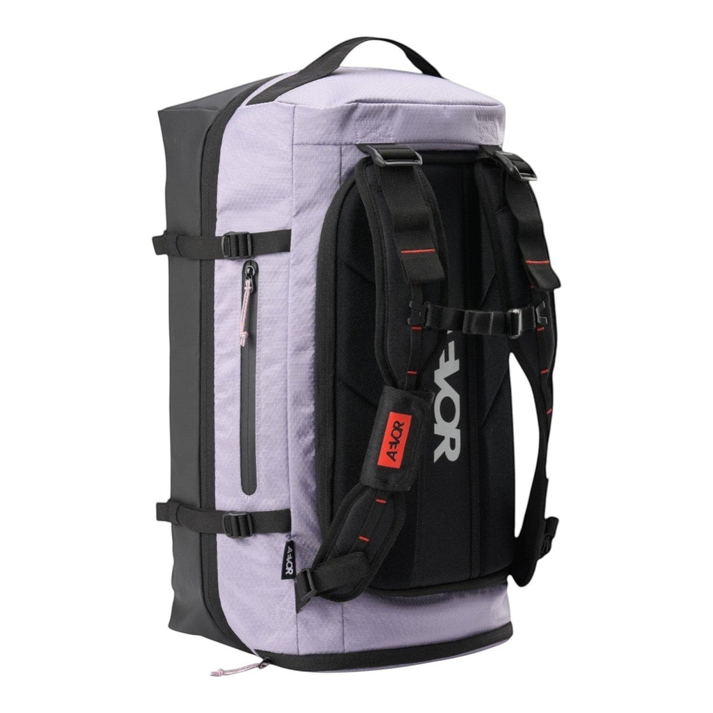 Lieblingstasche Duffel Pack in light purple and black with ergonomic shoulder straps and expandable storage design.