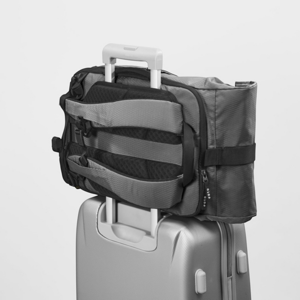 Lieblingstasche eoto Rolly32 grey rolltop backpack with trolley tunnel attached to a suitcase handle