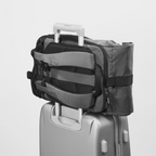 Lieblingstasche eoto Rolly32 grey rolltop backpack with trolley tunnel attached to a suitcase handle