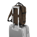Lieblingstasche eoto Small16 brown compact daypack attached to a silver trolley suitcase handle