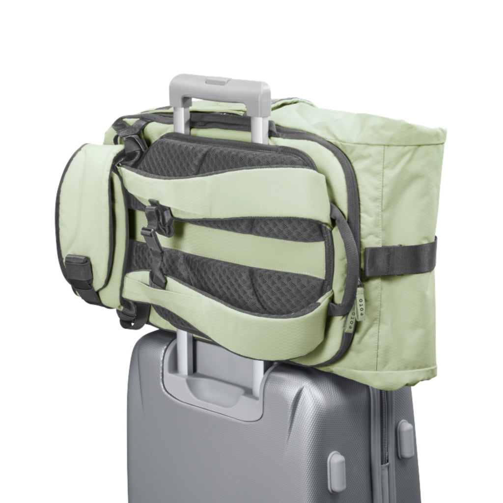 Lieblingstasche eoto Tall41 light green rolltop travel backpack with trolley sleeve attached to a suitcase