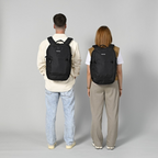 Lieblingstasche eoto Tidy22 black minimalist business backpack worn by a man and a woman against a grey background