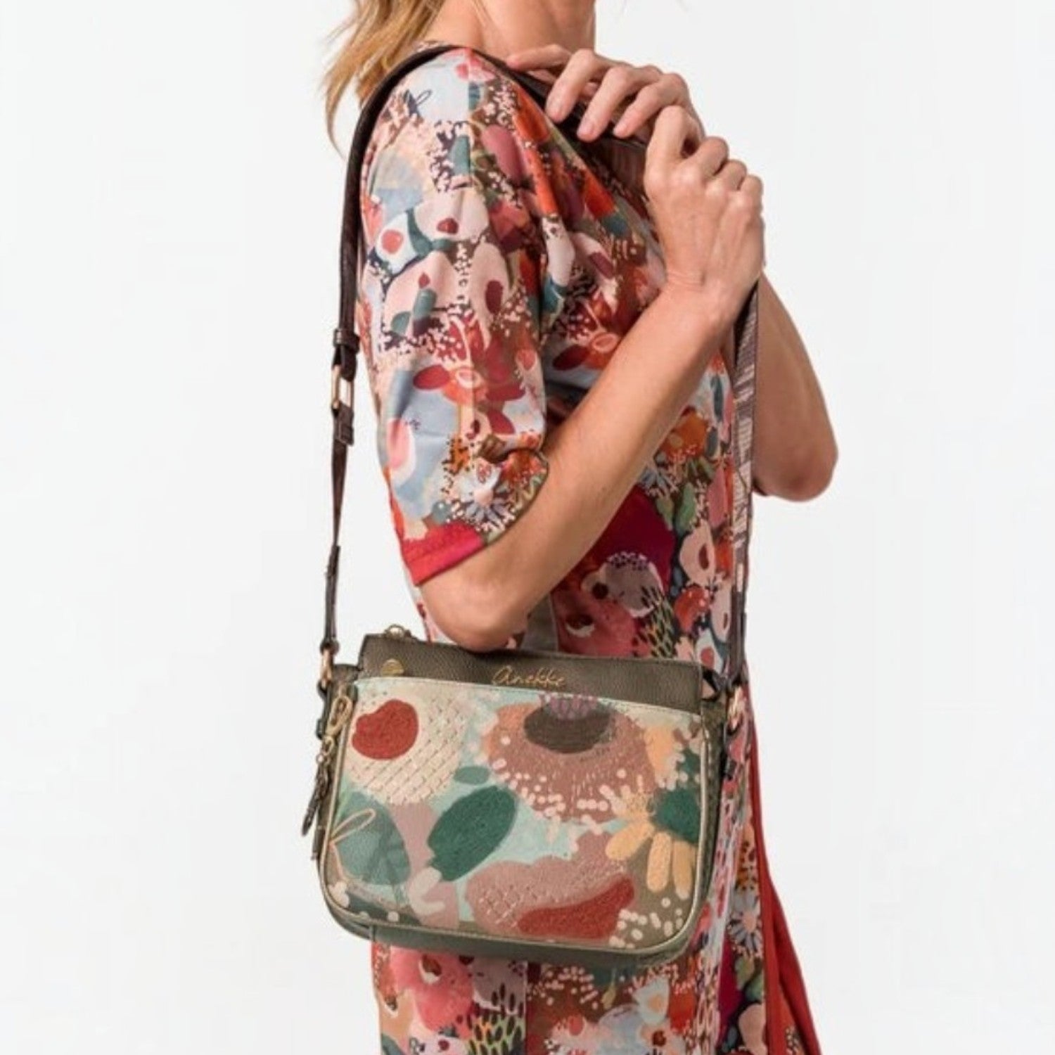 Lieblingstasche cross-body bag with floral embroidery and olive green trim worn by a woman in a matching dress