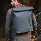 Lieblingstasche a/u by aunts & uncles Fukui blue rolltop backpack with leather details worn by a man