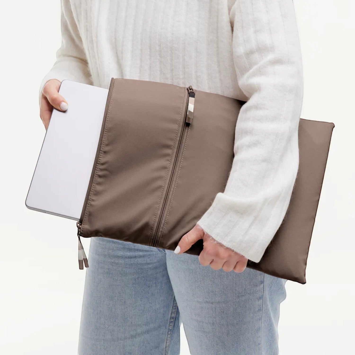 Lieblingstasche GOT BAG Rolltop Lite 2.0 brown laptop sleeve being held by a person in a white sweater