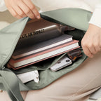 Lieblingstasche GOT BAG Moon Bag Large in sage green showing interior compartments with books, phone, and bottle.