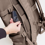 Lieblingstasche GOT BAG Rolltop 2.0 backpack in taupe showing the secure zippered back pocket with a smartphone