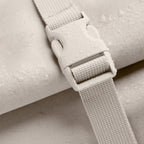 Lieblingstasche GOT BAG Rolltop 2.0 backpack detail showing beige water-repellent fabric and a sturdy plastic buckle