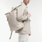 Lieblingstasche GOT BAG Rolltop Easy backpack in beige worn by a man in a matching jacket against a white background