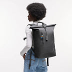 Lieblingstasche GOT BAG Rolltop Lite 2.0 black backpack with magnetic closure worn by a model against white background