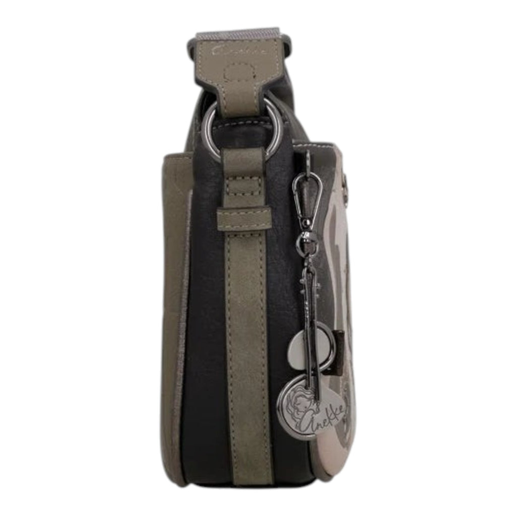 Side view of a Lieblingstasche cross-body bag in grey and black with decorative metal charms and adjustable strap