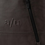 Lieblingstasche a/u by aunts & uncles Hamamatsu backpack detail featuring dark brown coated canvas and zipper pocket
