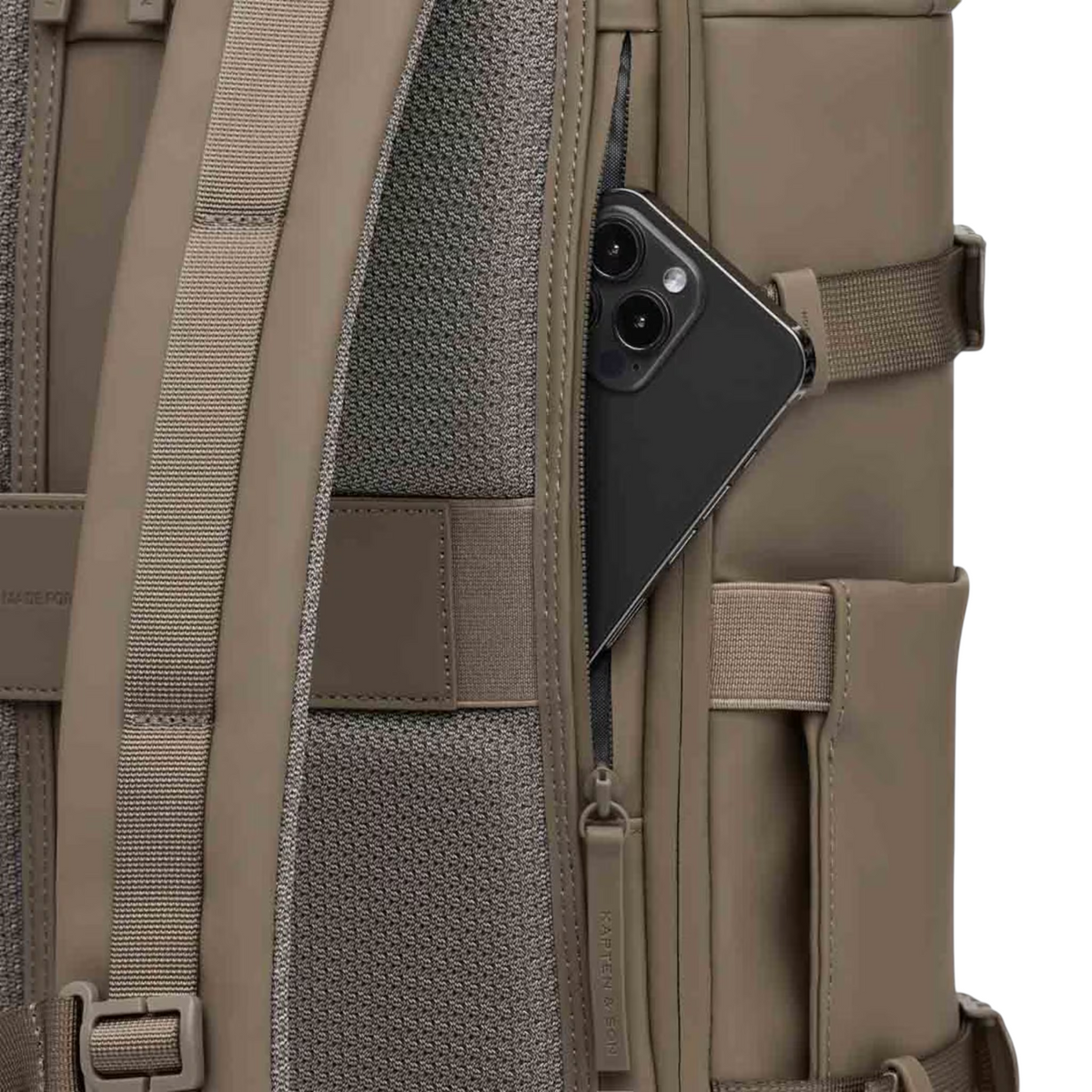 Lieblingstasche Helsinki Pro backpack in taupe featuring a side zipper pocket with a smartphone tucked inside.