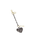 Lieblingstasche heart charm with grey leopard print pattern, gold-tone hardware, and a matching leather strap.