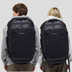 Lieblingstasche Lisbon Duffle Backpack L in black worn by a man and a woman, showing a versatile travel bag design.