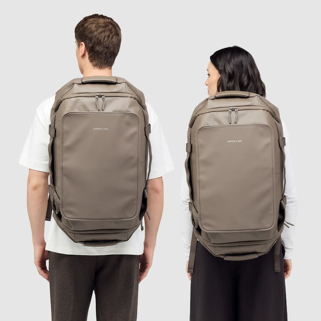Lieblingstasche Lisbon Duffle Backpack L in taupe worn by a man and woman, showing a versatile travel bag design.
