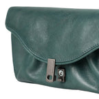 Lieblingstasche Mabel dark green leather clutch bag with a sleek metal clasp closure on a white background